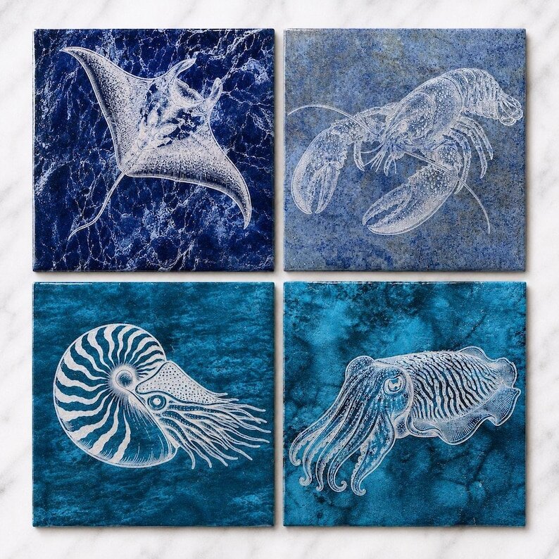 Four glazed ceramic tiles engraved with a manta ray, lobster, nautilus, and cuttlefish in Bali Blue and Turquoise Reef